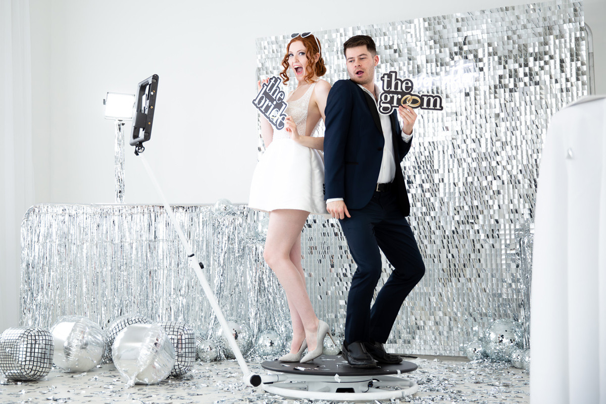 bride and groom in photo booth